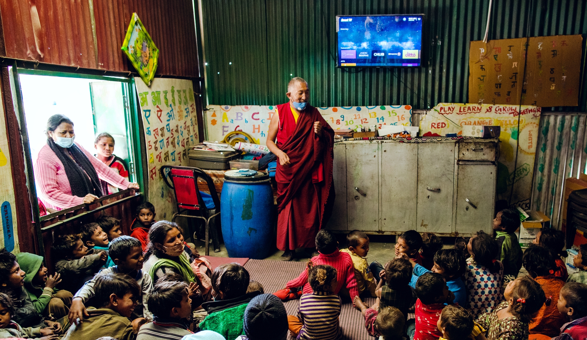 man speaking to children