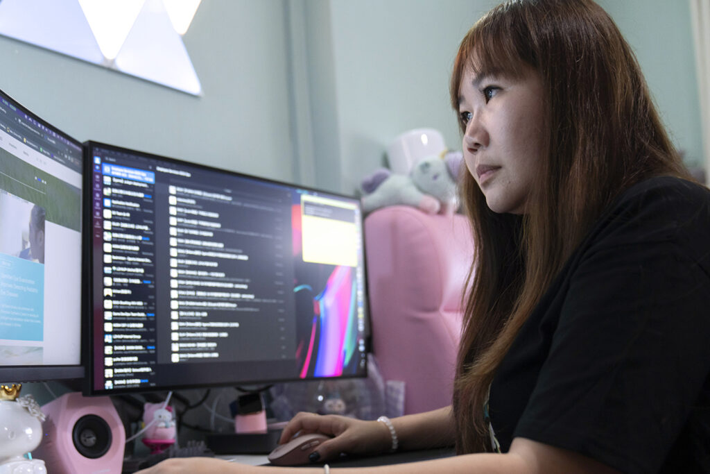 woman looking at computer monitors