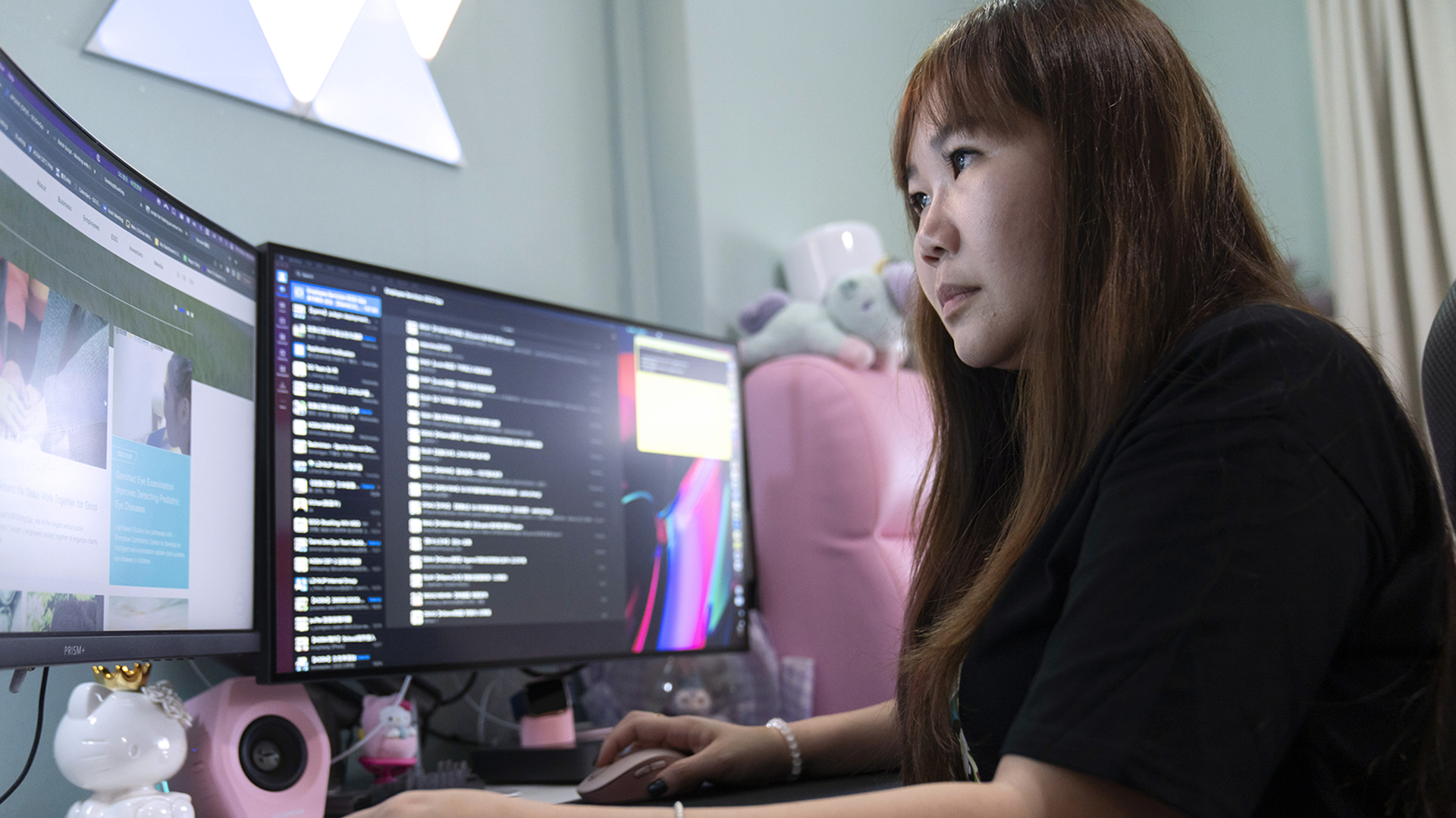 woman looking at computer monitors