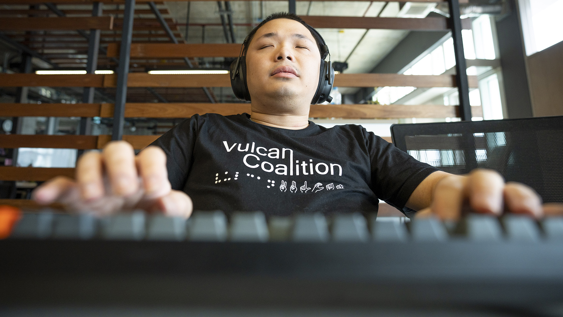 man with eyes closed wearing headphones