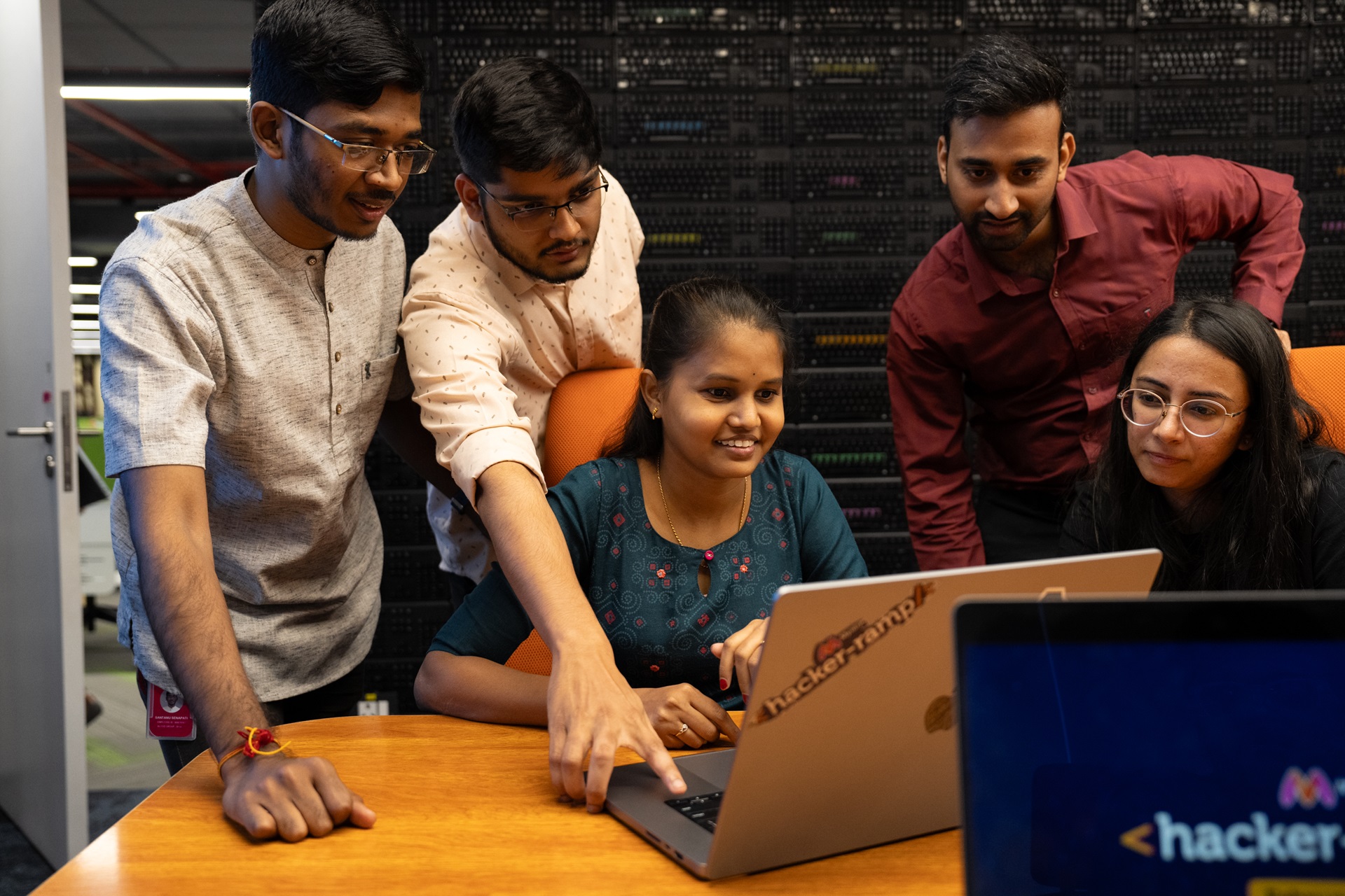 Photo of a group of people looking at a computer