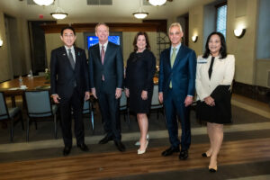 Five people stand in a conference room