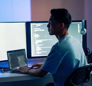 Image depicting person working on a laptop, signing into Azure