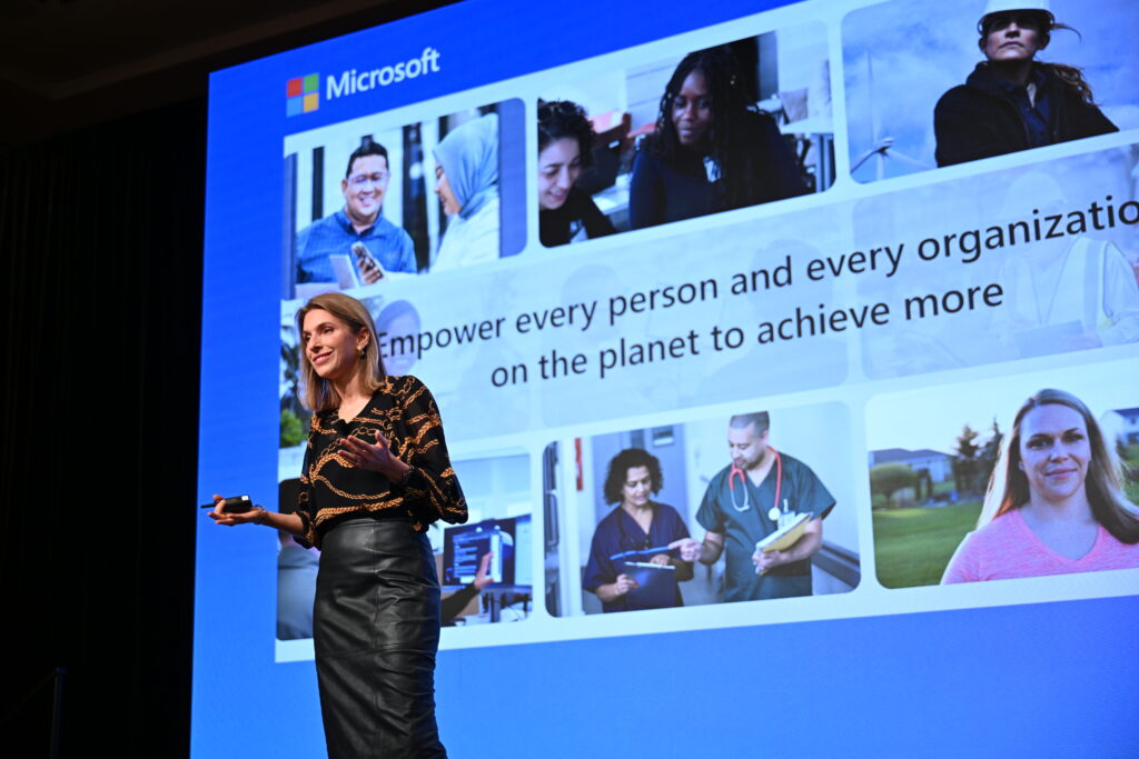 A woman giving a keynote speech on stage