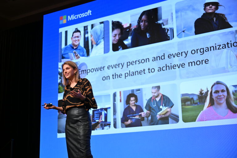 A woman giving a keynote speech on stage