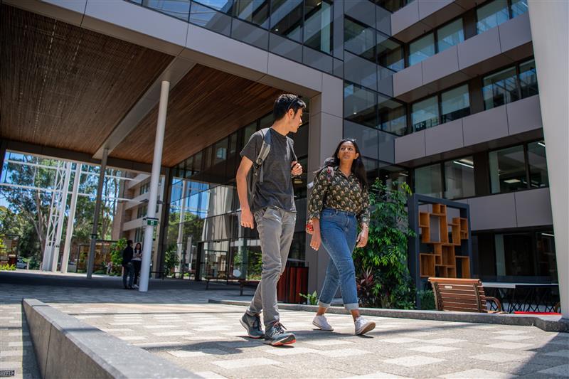 Two students walking through the University