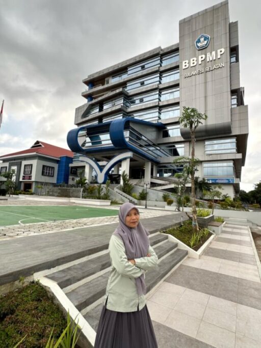 A woman standing in front of the BBPMP building